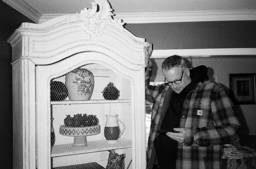 a couple of men looking at a display of pottery