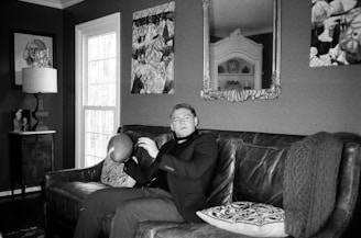 A confident lawyer reviewing football contracts in a sleek modern office with football memorabilia.