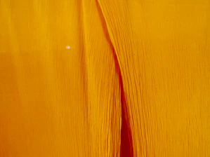 Close-up of luxurious lemon wear fabric textures in soft pastel tones, highlighting fine stitching and quality.