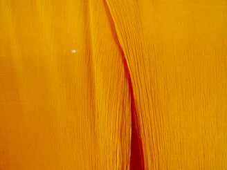 Close-up of soft cotton fabric of lemon wear pajamas with a gentle lemon yellow background.