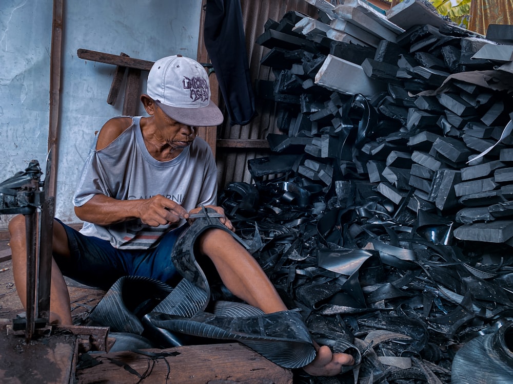 a person sitting on a pile of rubble
