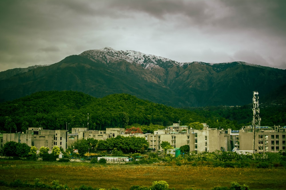 a large building with a mountain in the background