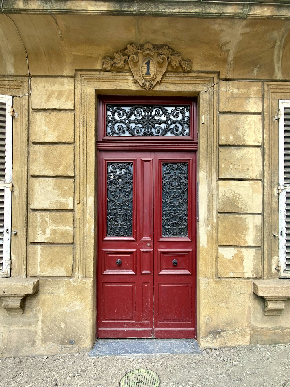 a red door on a stone building