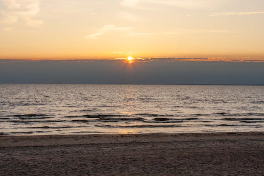 a beach with a sunset