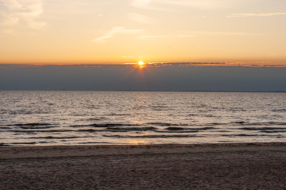 a beach with a sunset