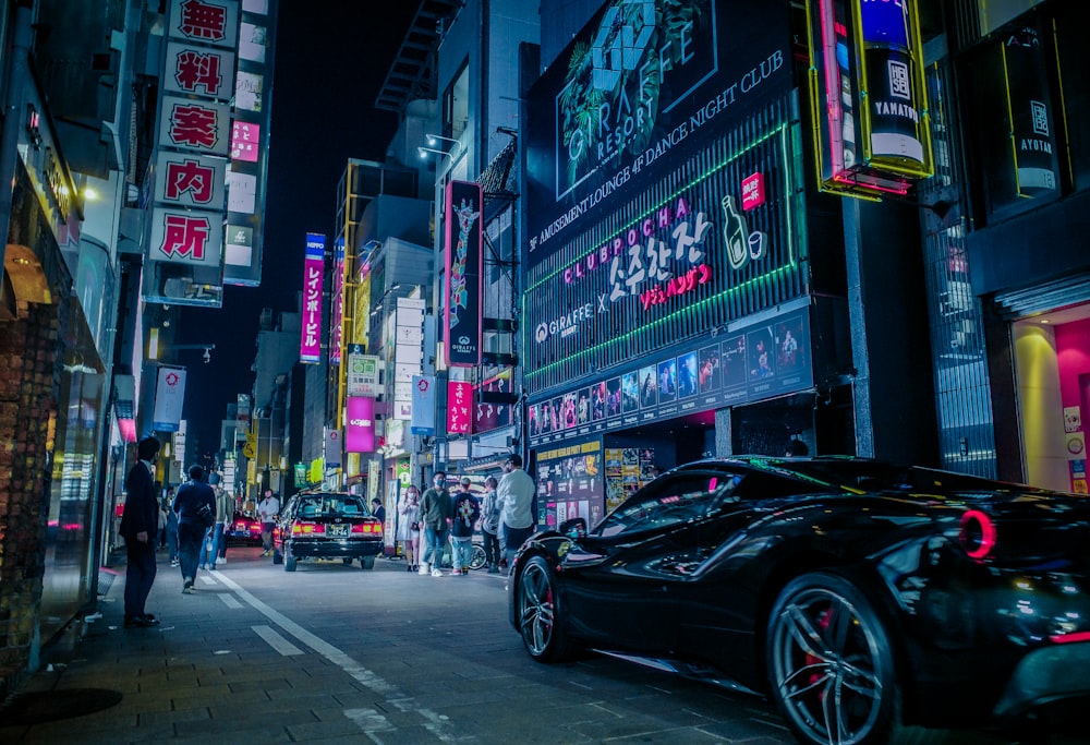 a street with cars and people on it with buildings in the back