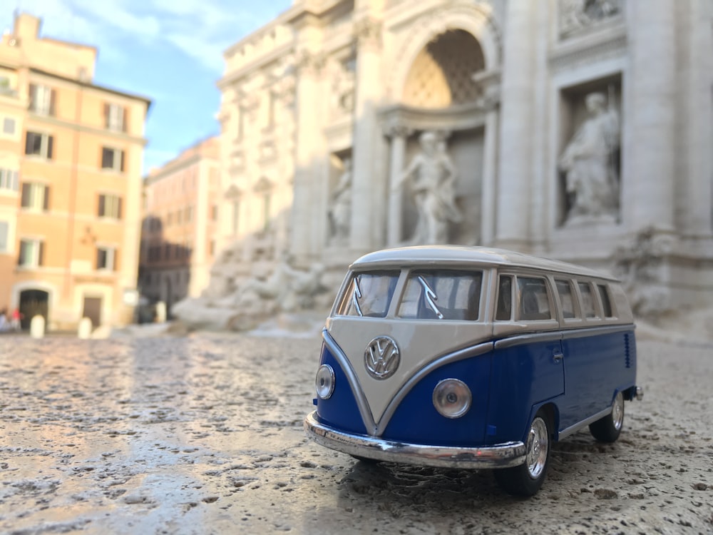 a blue car parked in front of a building