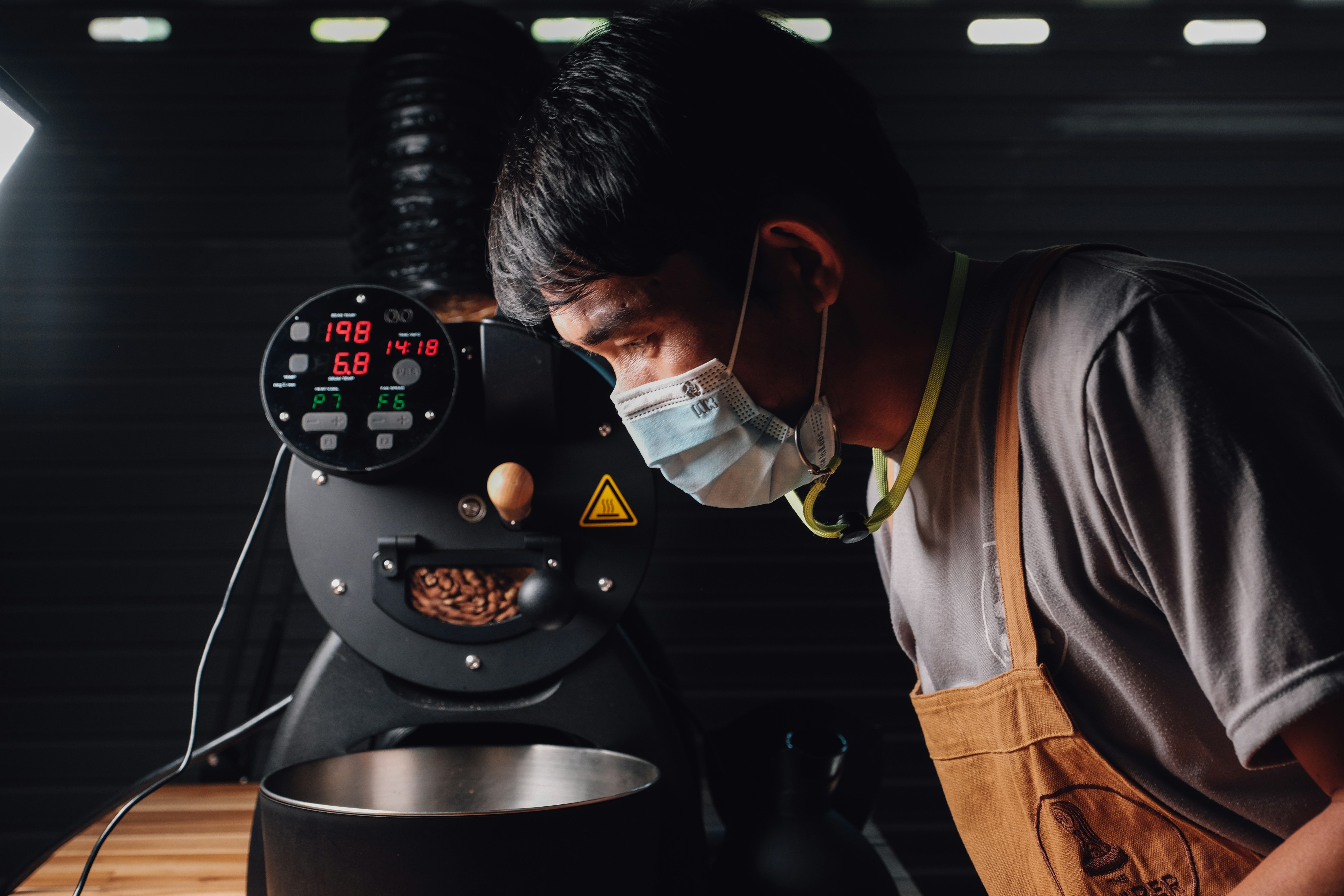 a man wearing headphones and working on a machine