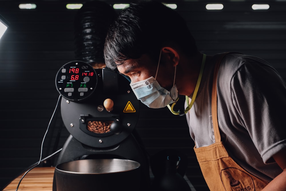 a man wearing headphones and working on a machine