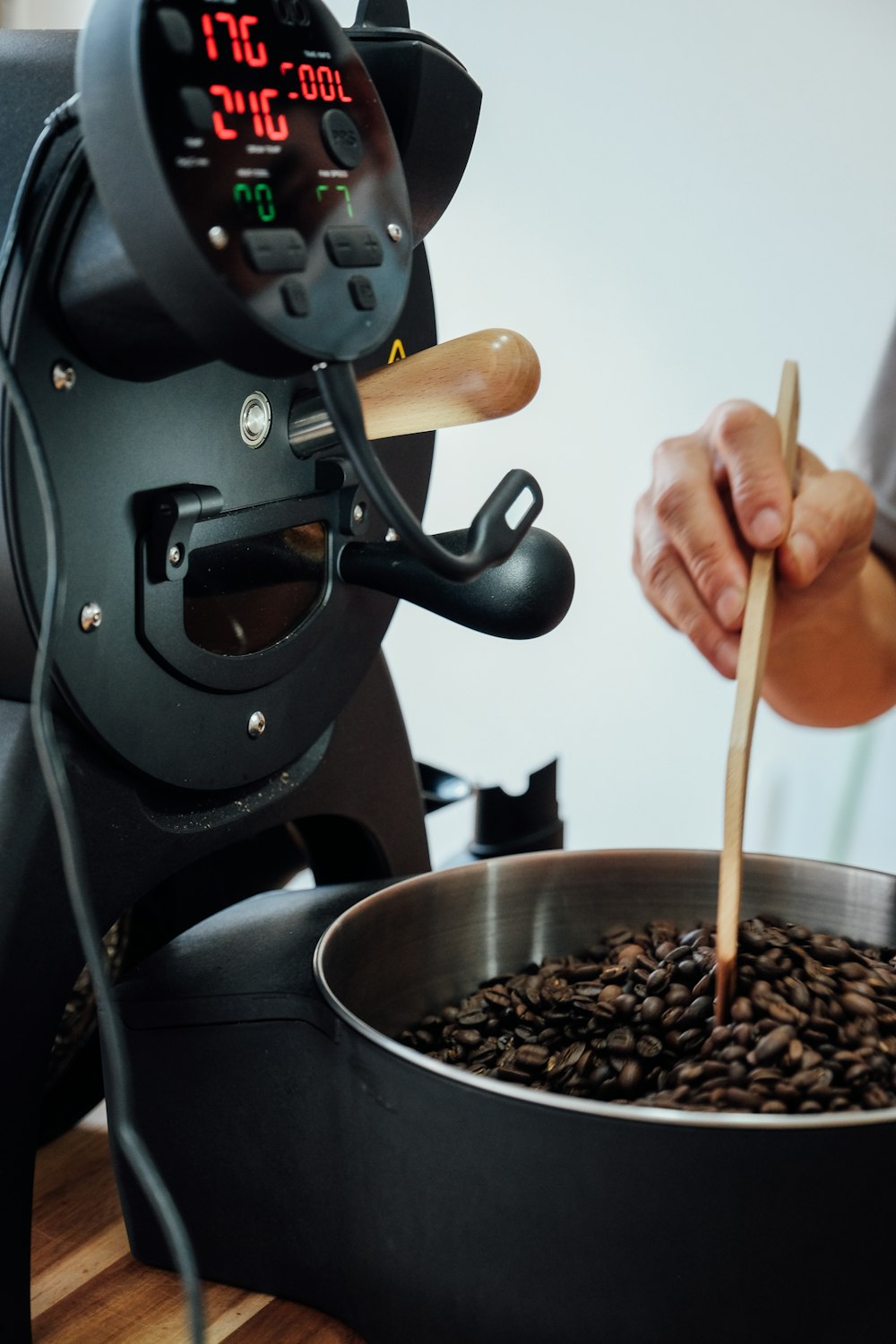 a person pouring a liquid into a pot