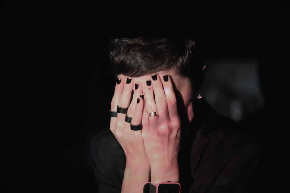 a person covering the face with the hands