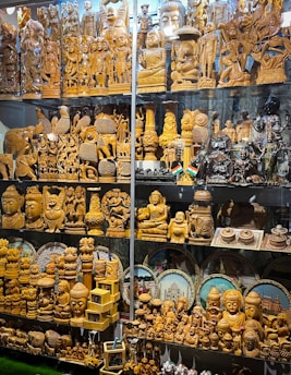 A vibrant display of handcrafted wooden sculptures showcasing intricate Indian artistry.