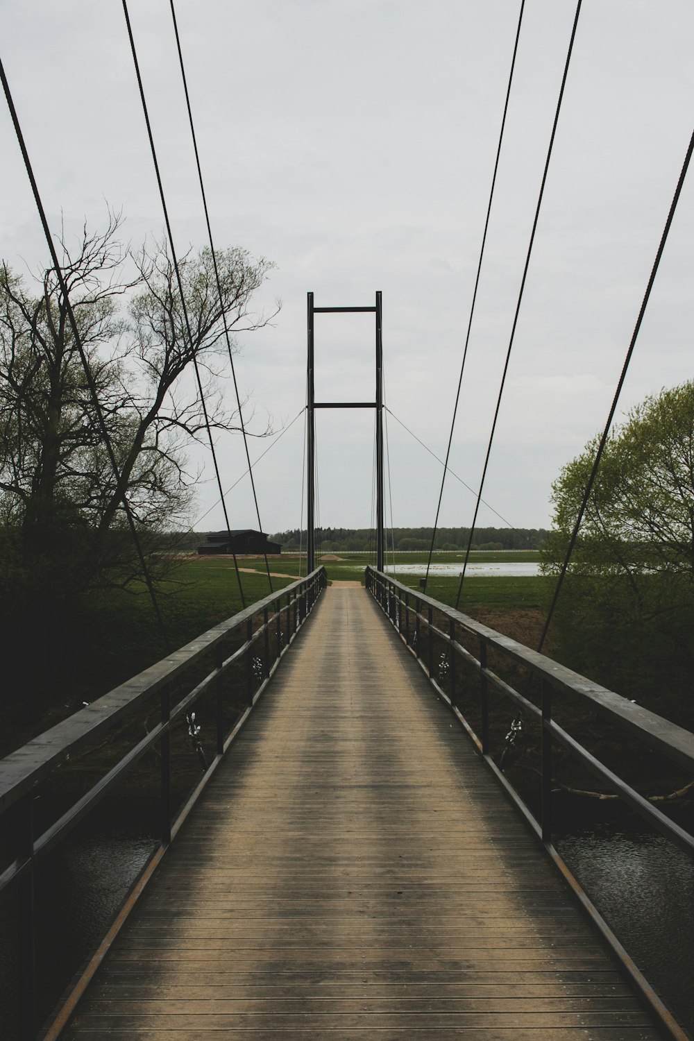 a wooden bridge with a wooden walkway