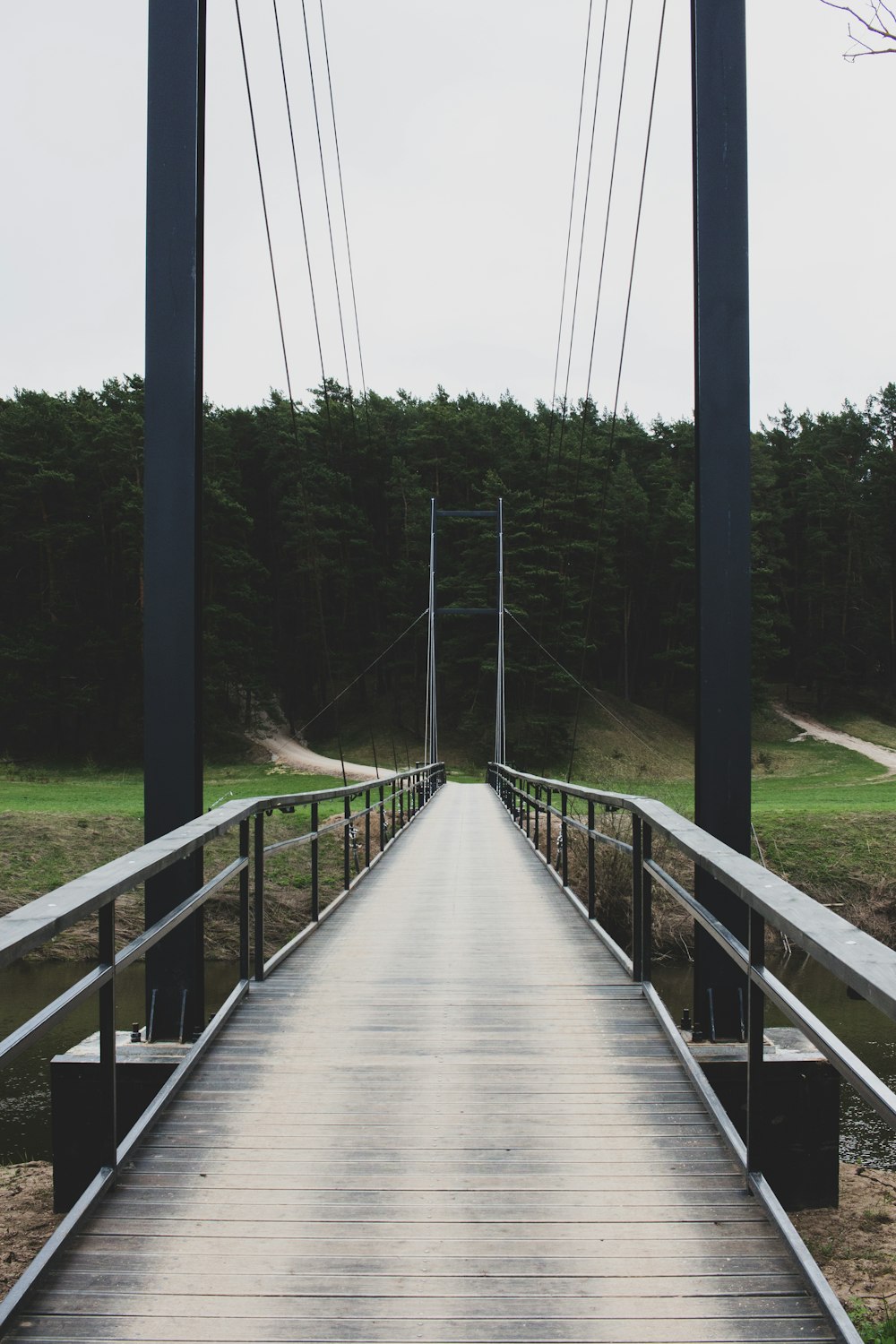 a wooden bridge with a railing