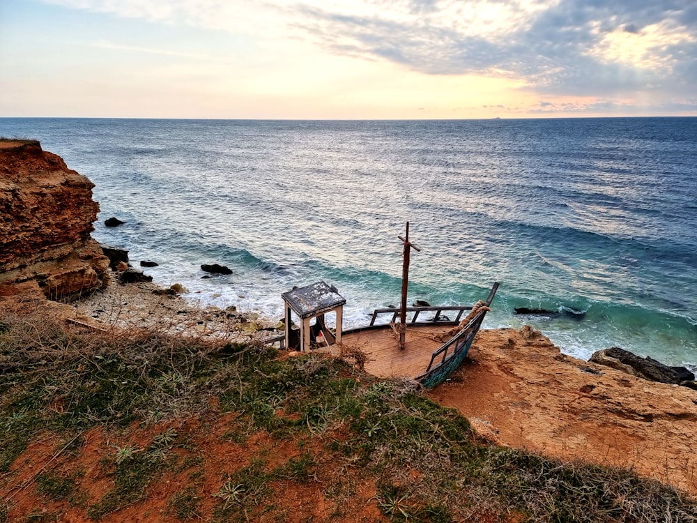 a bench on a rocky beach