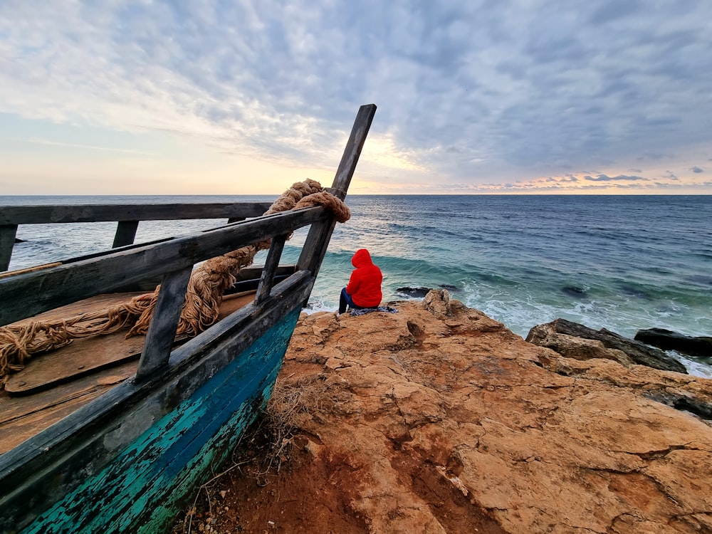 a person sitting on a bench by the water