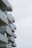 A series of wavy, modern balconies extending from a building against a light sky, each balcony featuring glass railings.