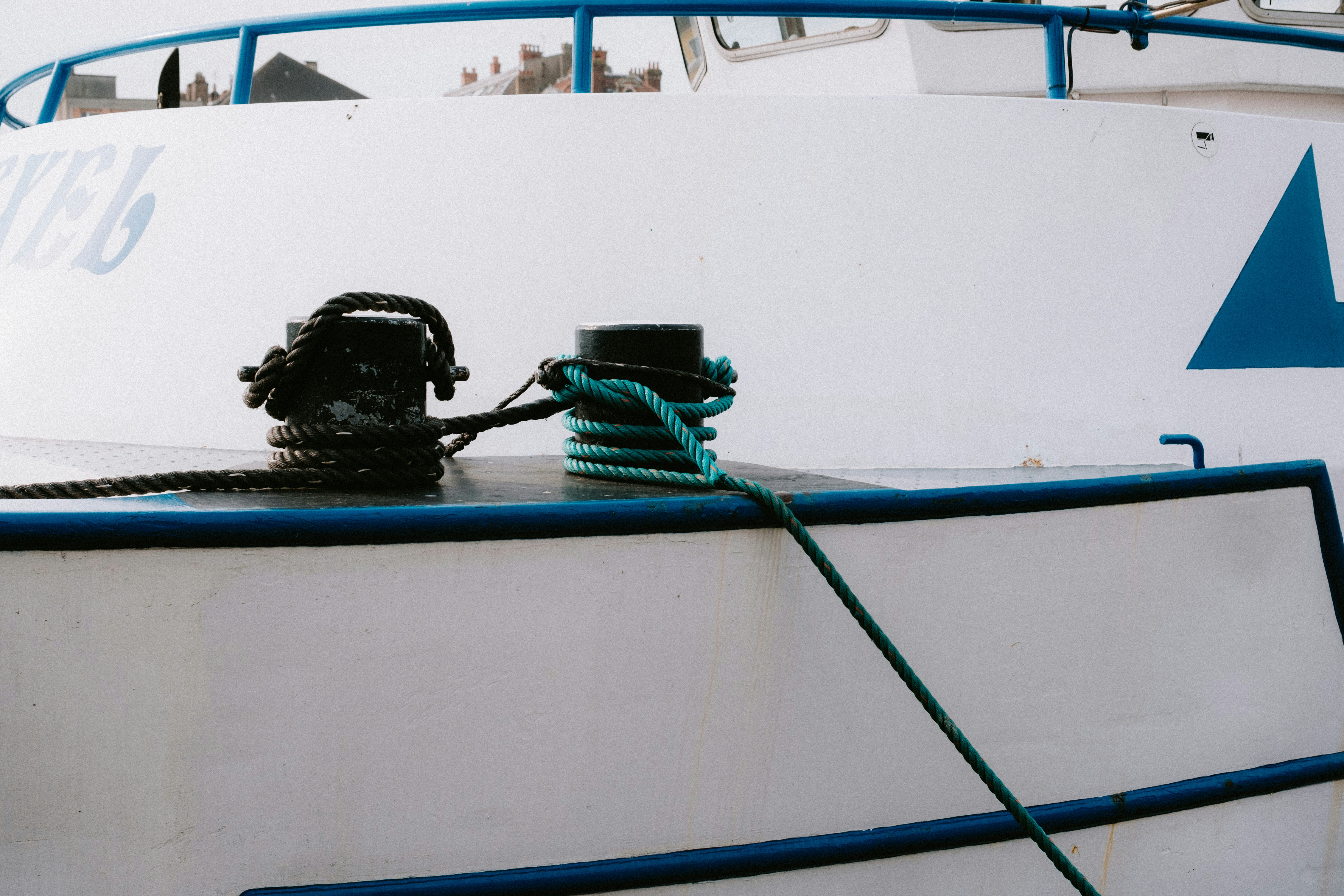 a group of black bags on a white boat