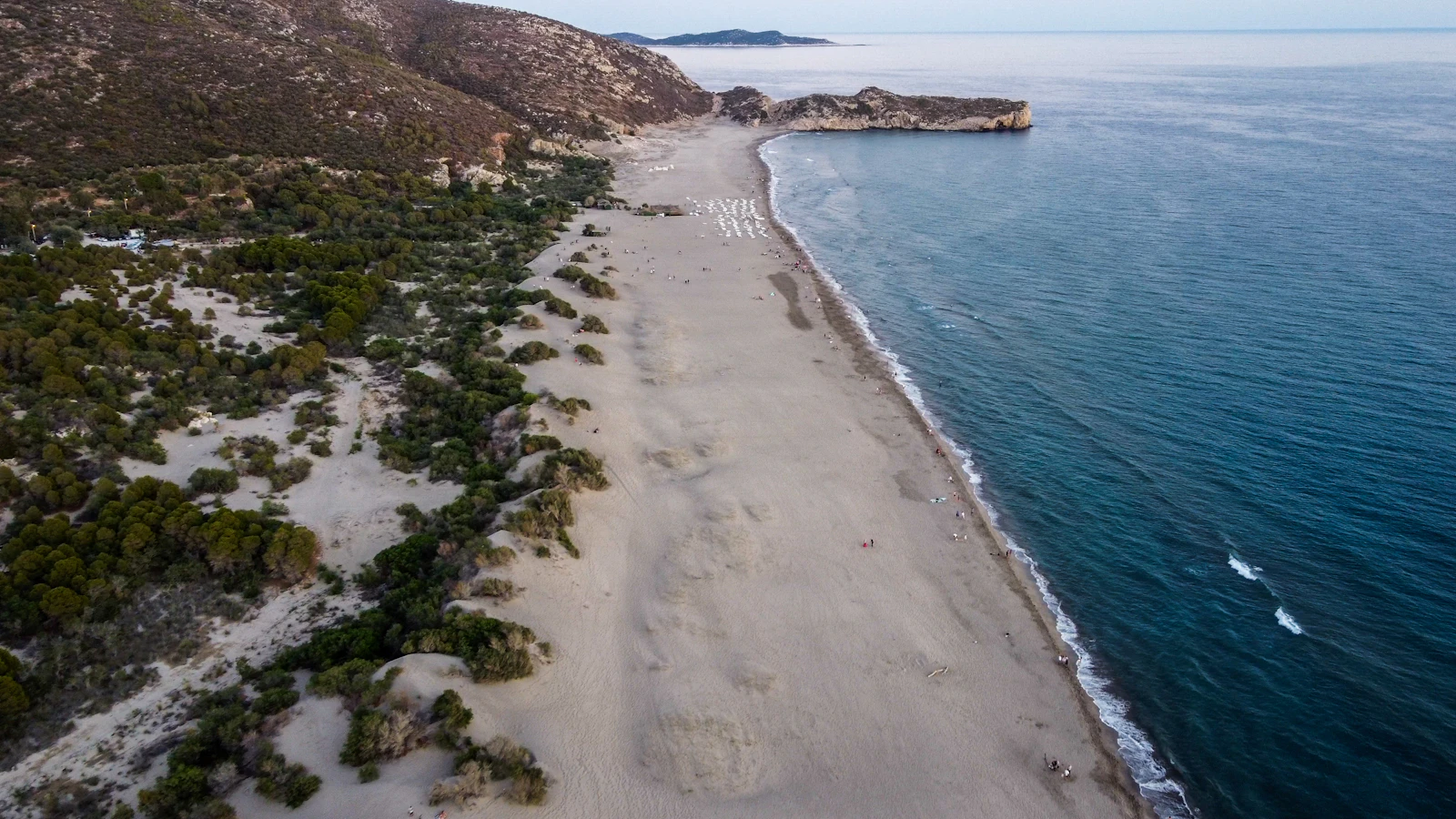 The long empty sand of Patara beach, dunes and scrub behind it
