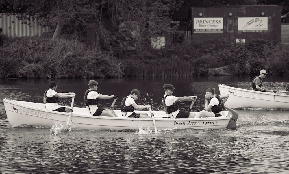 a group of people rowing a boat