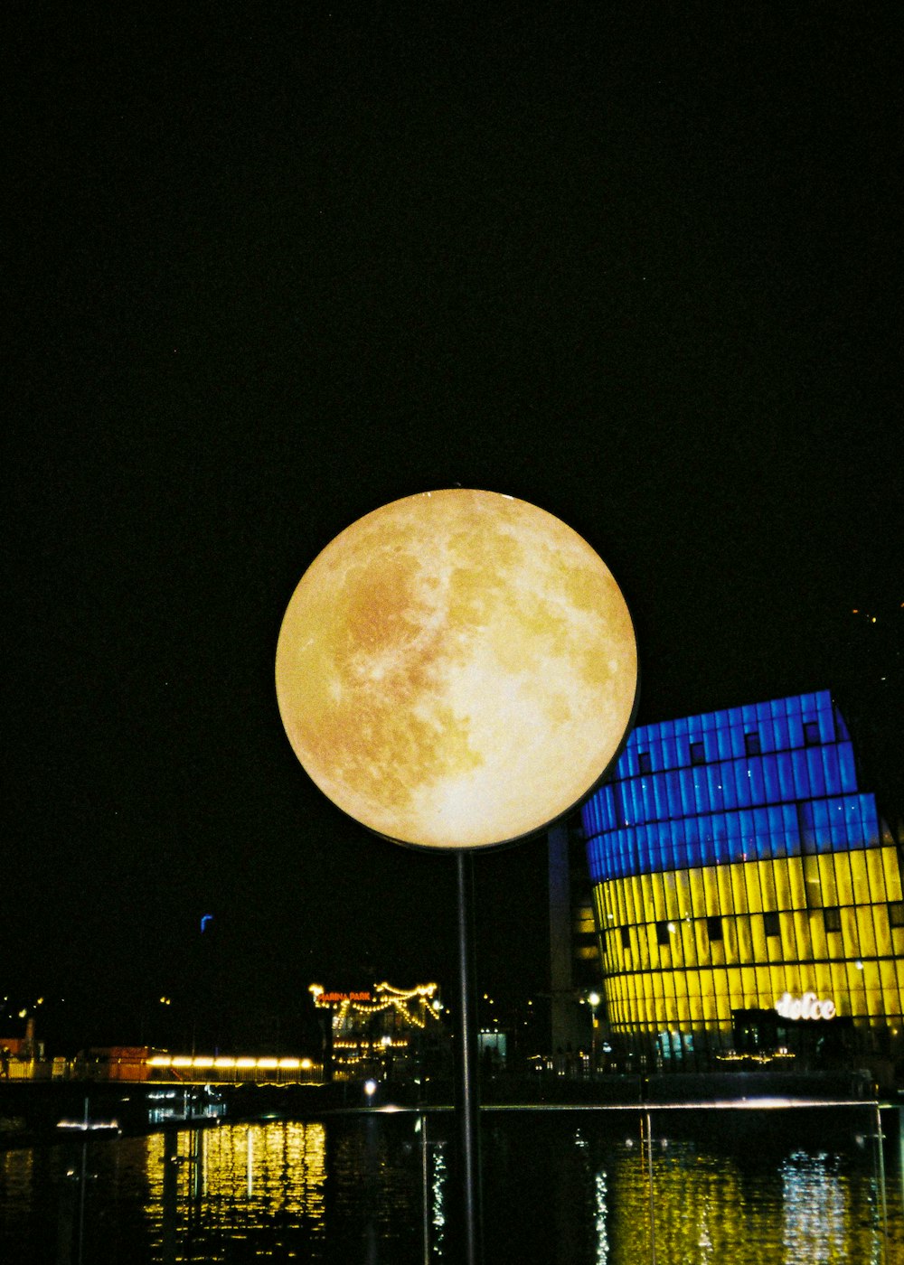 a full moon over a city
