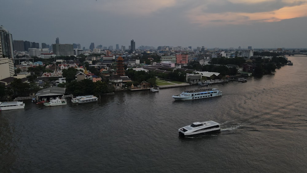a river with boats in it and a city in the background