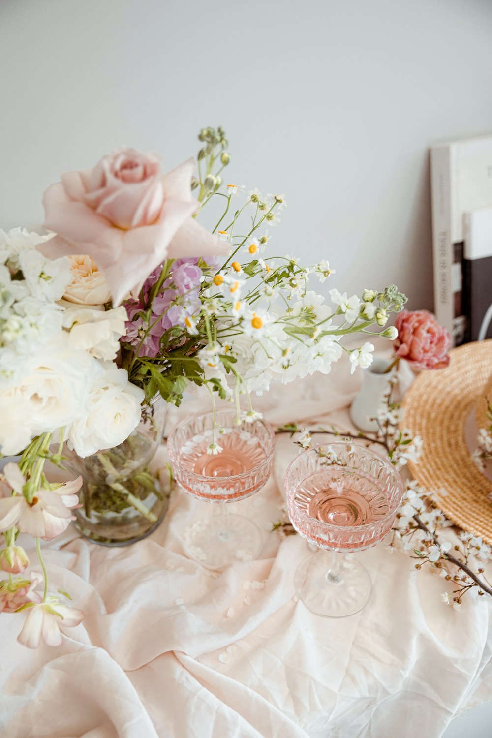 a table with flowers and a vase of flowers