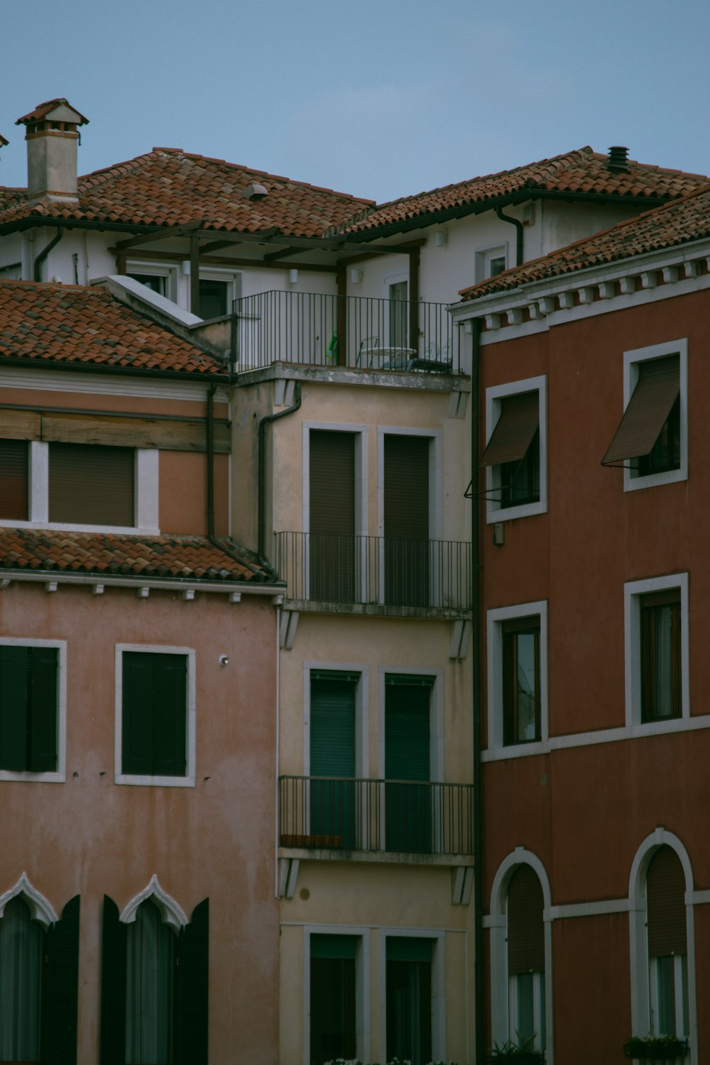 a row of buildings with balconies and a blue sky