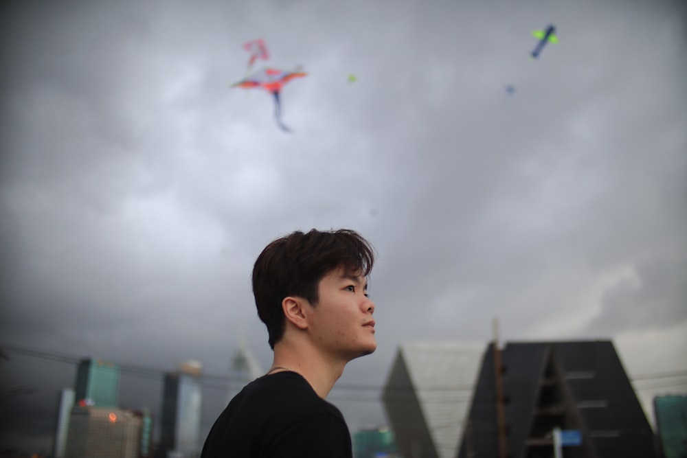 a man looking at a kite