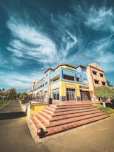 Colorful educational center entrance with blue, red, and yellow triangular patterns inspired by Rarámuri clothing.
