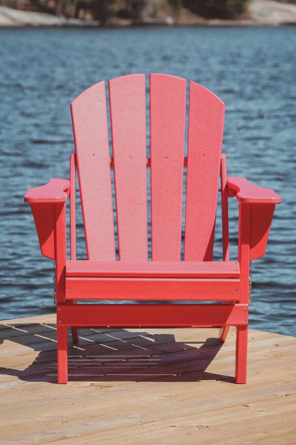 a red chair on a dock