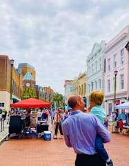 A young family exploring colorful city streets filled with street art and local markets.