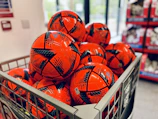 Rows of colorful soccer balls stacked neatly in the futbolis online store.