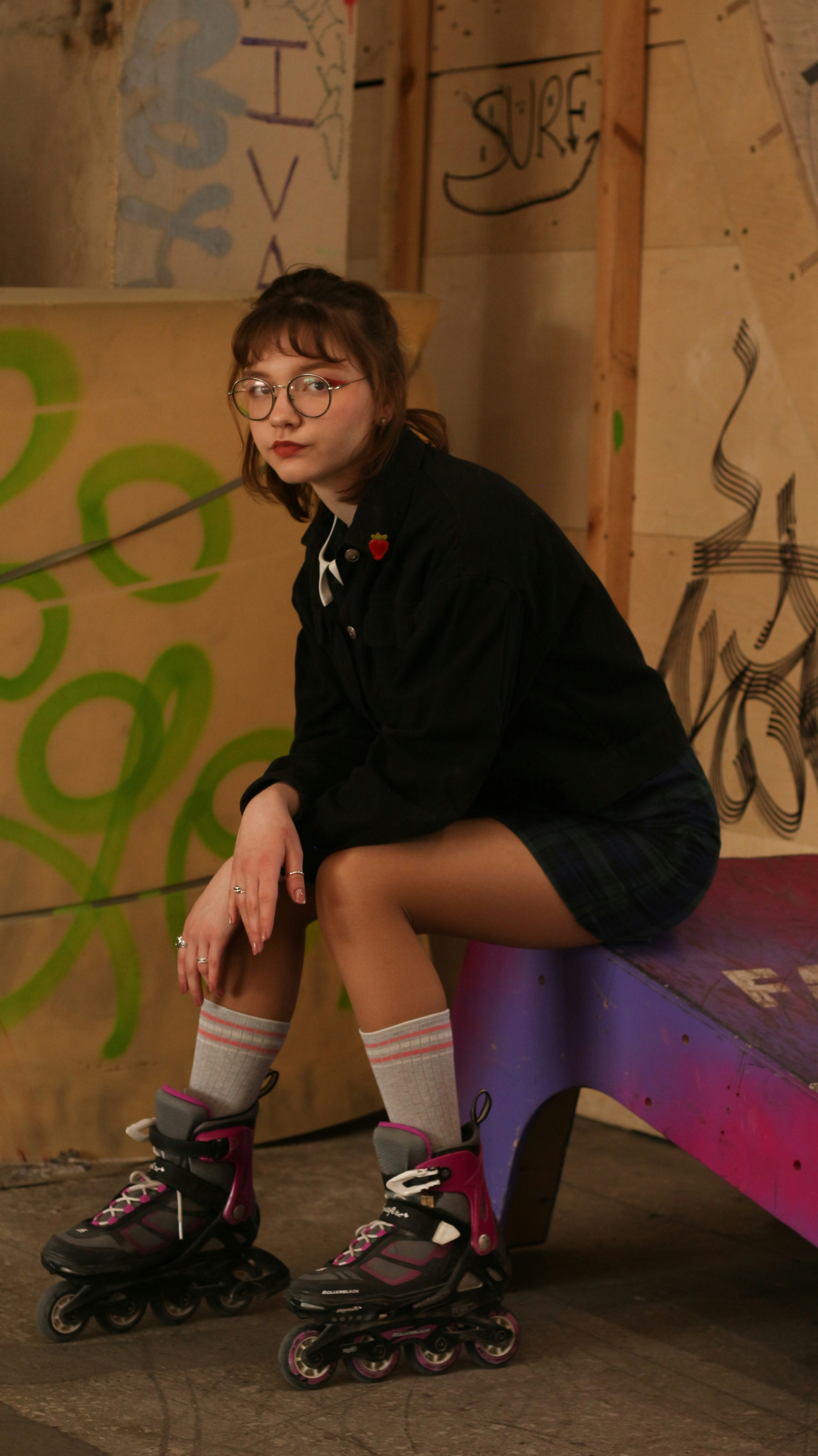 a girl sitting on a purple bench