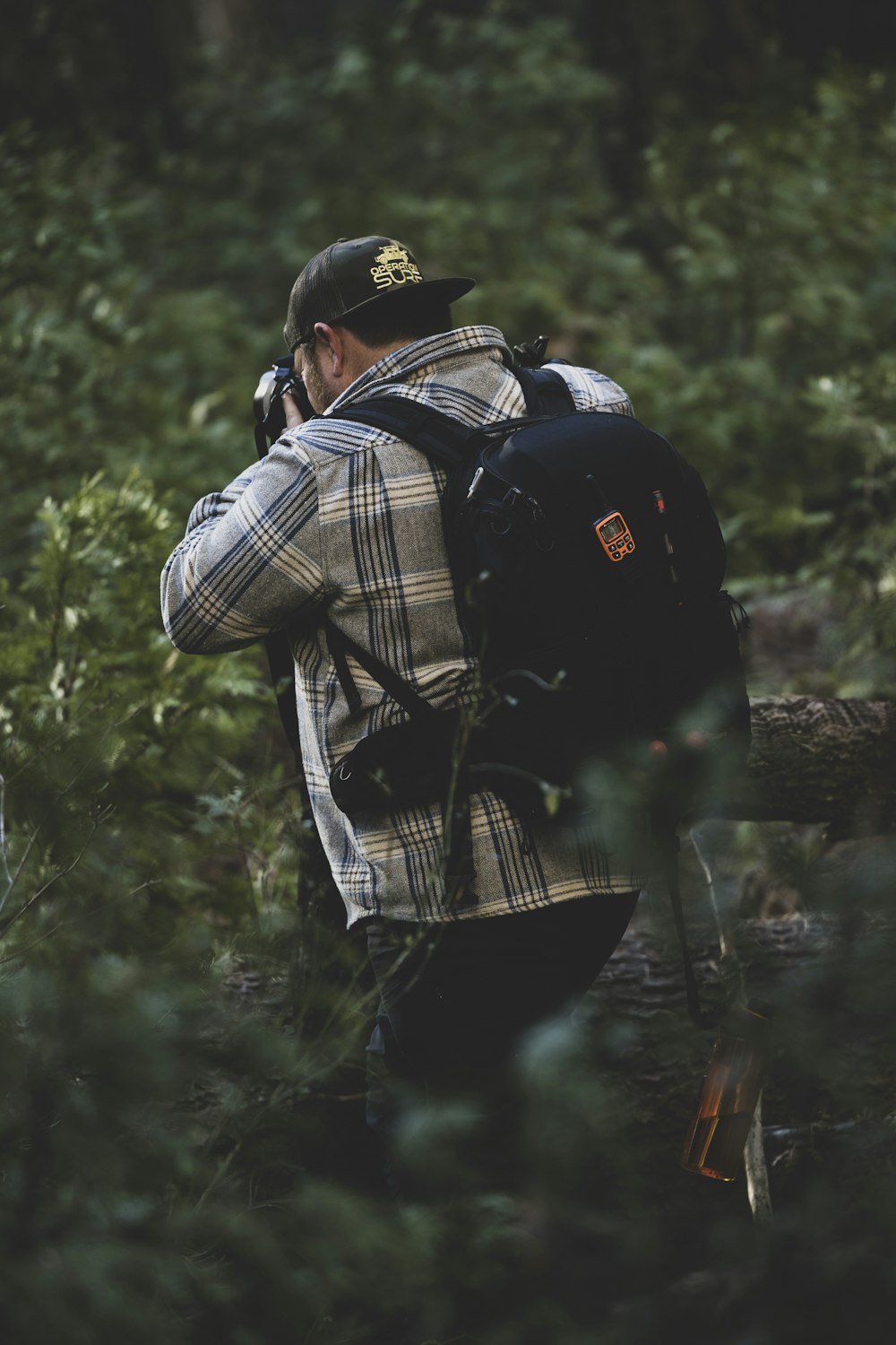 a man in a uniform carrying a backpack