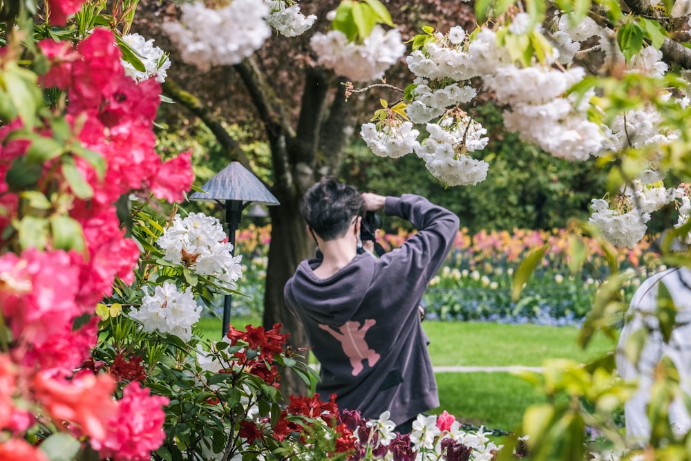 a person looking at flowers