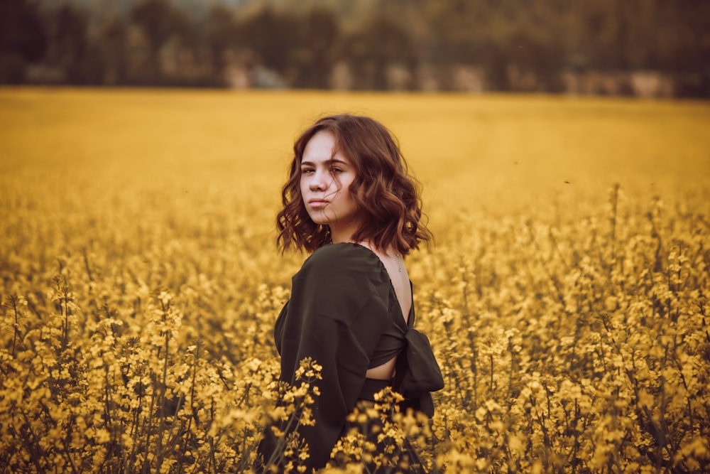 a person standing in a field of flowers