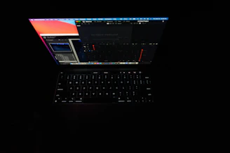 A glowing laptop screen showing an online store dashboard at night.