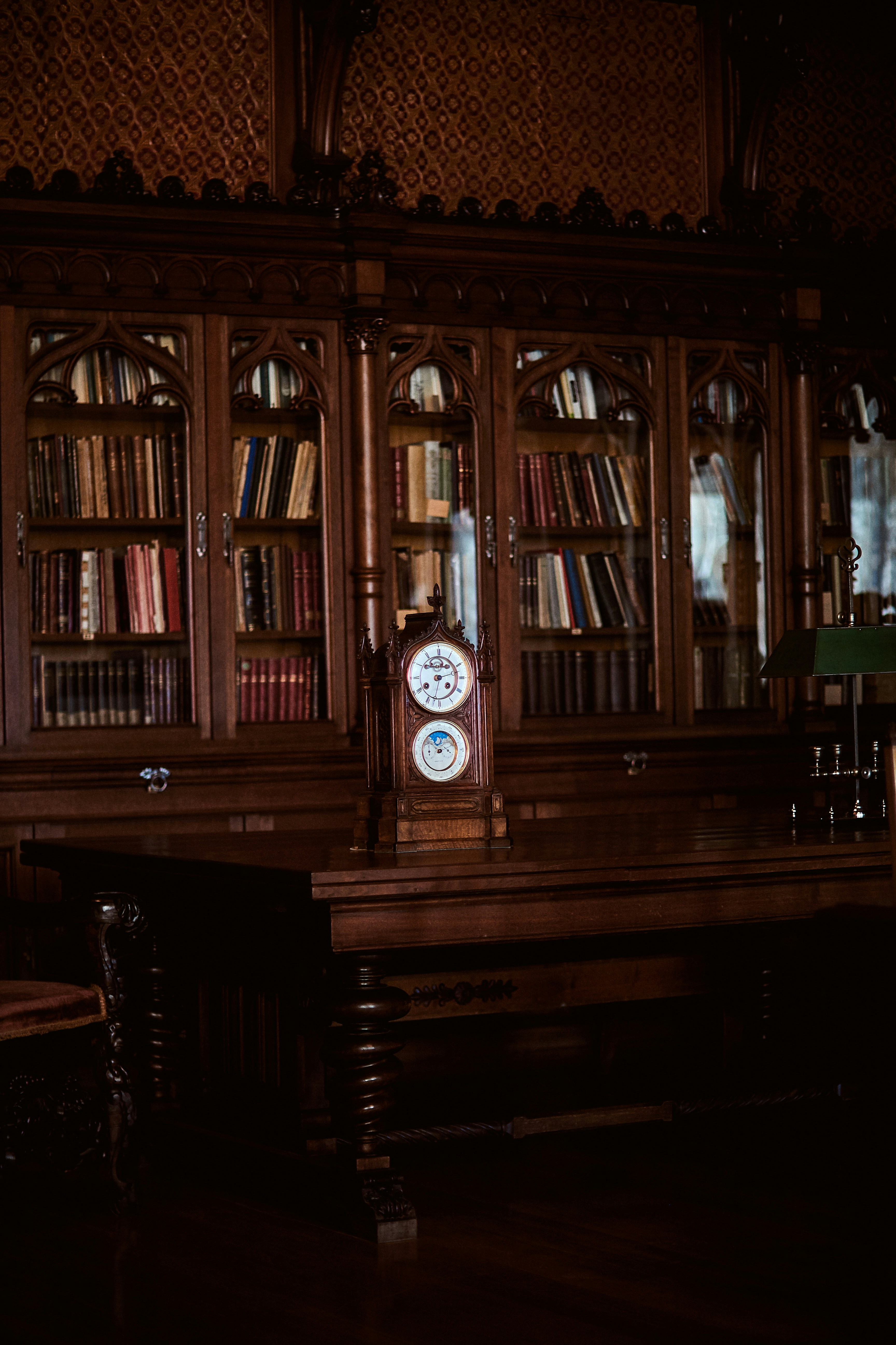 a clock on a book shelf