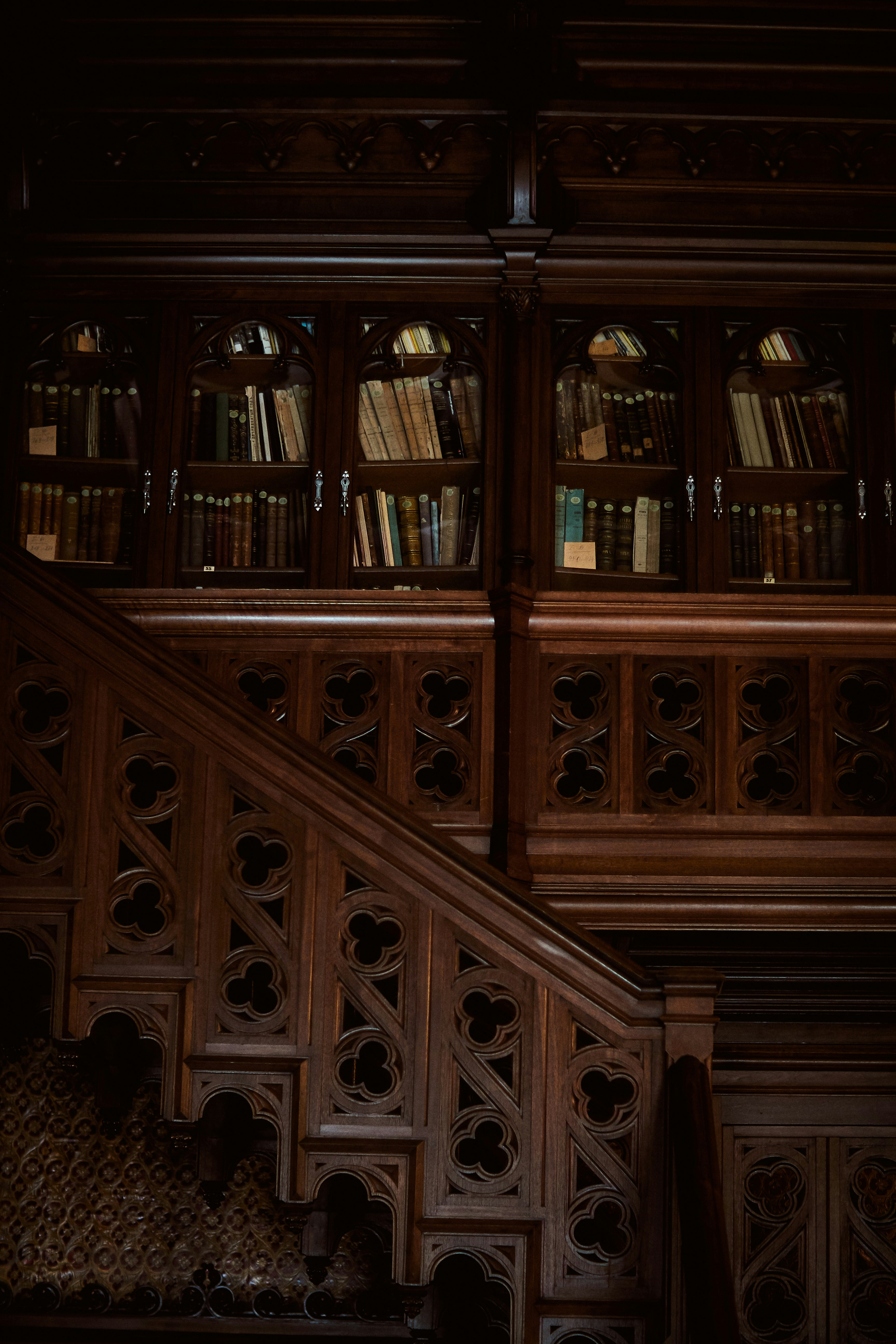 a large wooden cabinet with many books