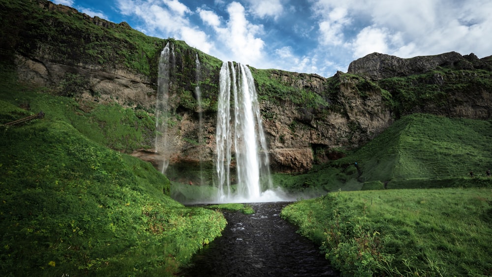 a waterfall in a valley