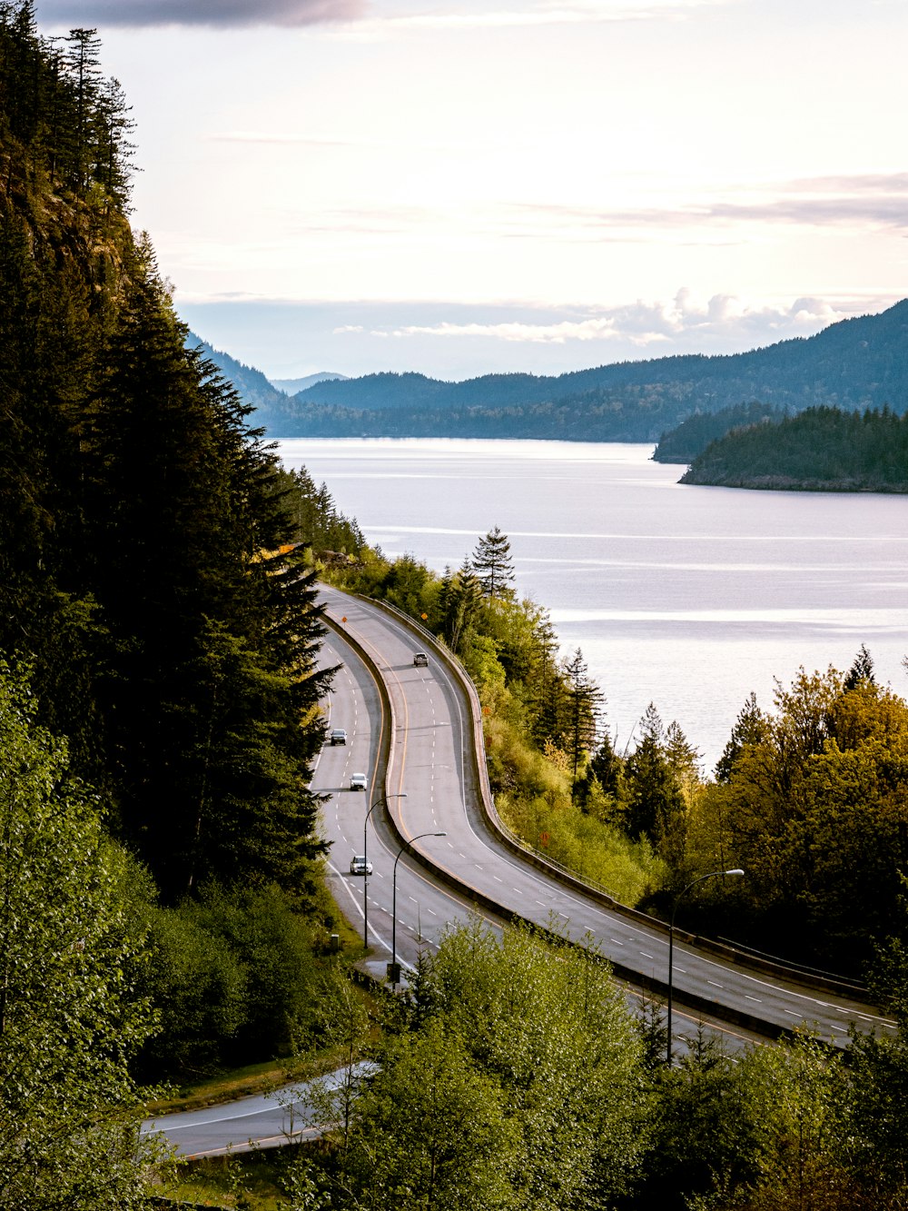 a highway with a river and trees