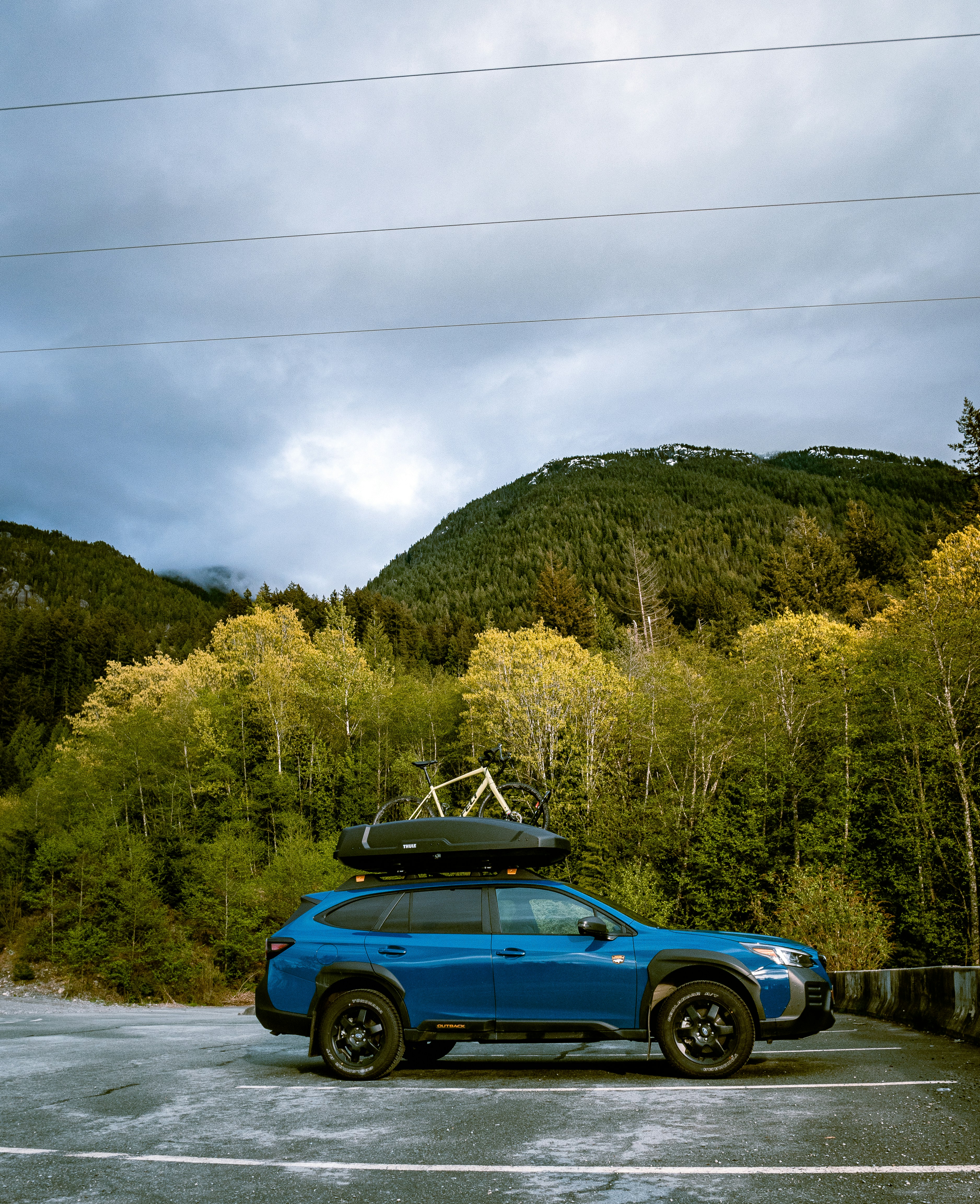 a blue car with a surfboard on top of it