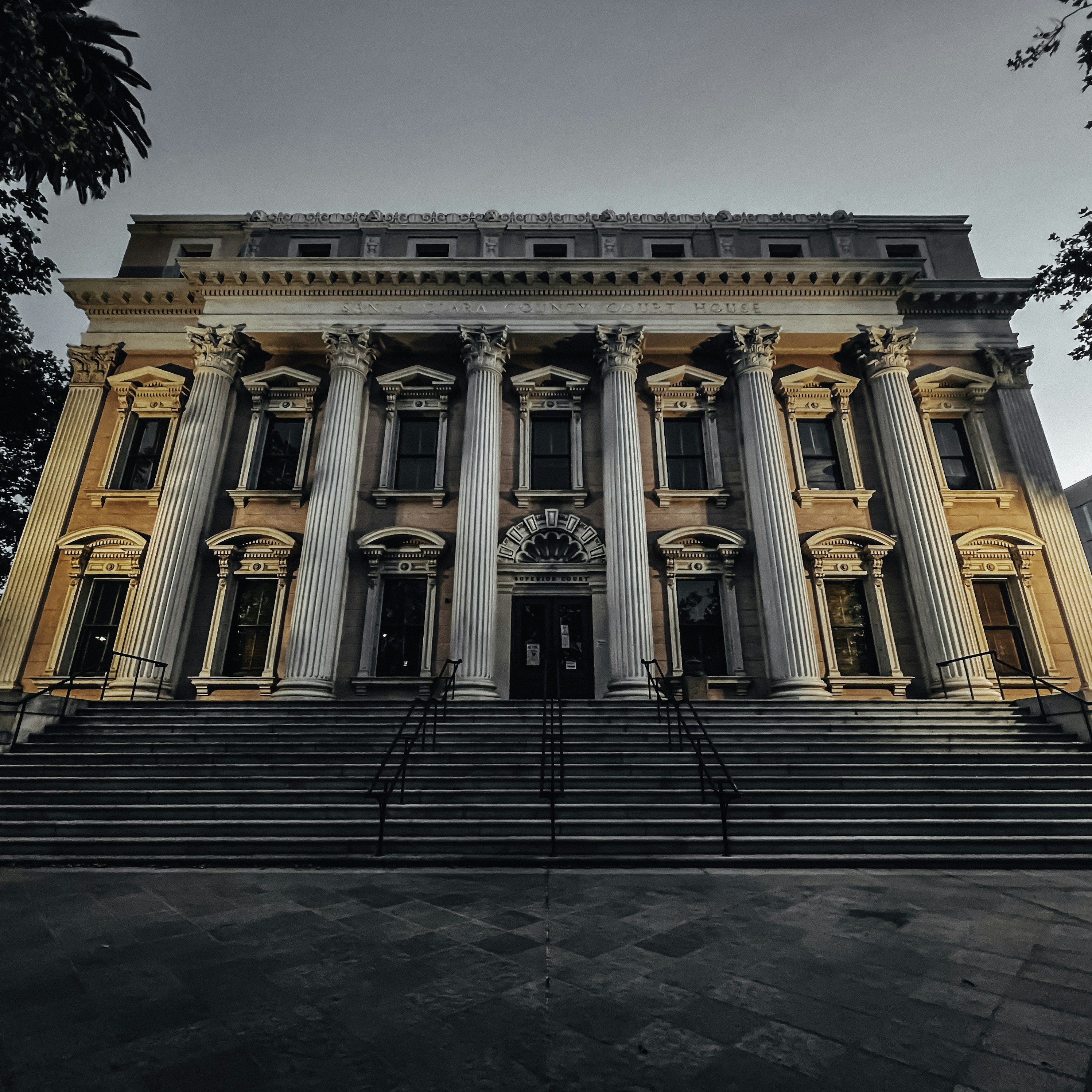 White columned courthouse with a grand staircase and entrance.