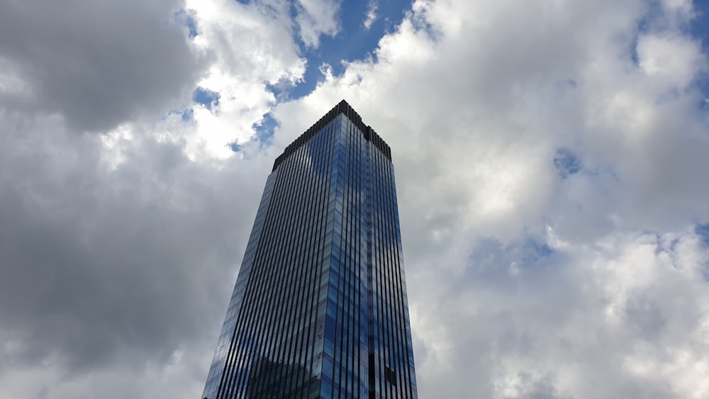 a tall building under a cloudy sky