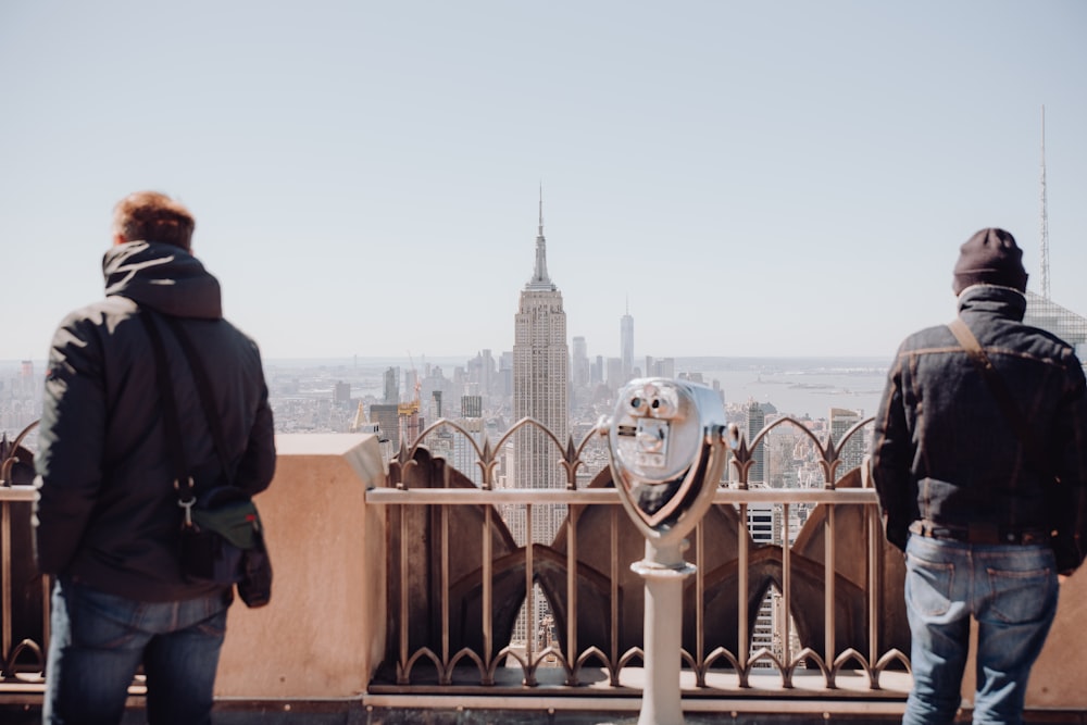 two people looking at a city