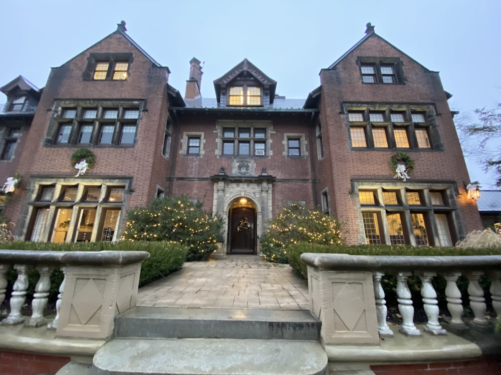 a large brick building with a fountain in front of it