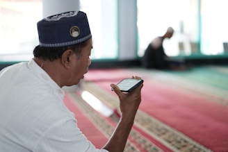 a man in a uniform looking at his phone