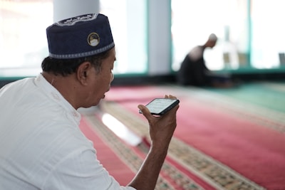 a man in a uniform looking at his phone