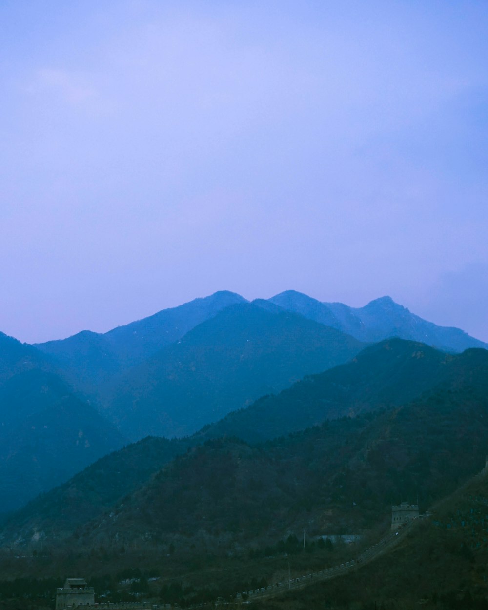 a valley with mountains in the background